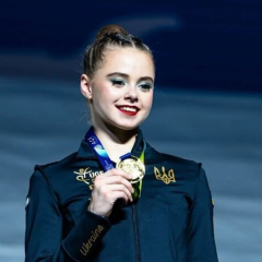 Ukrainian gymnast on podium with third place medal
