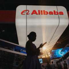 Alibaba company logo on the background of the American flag