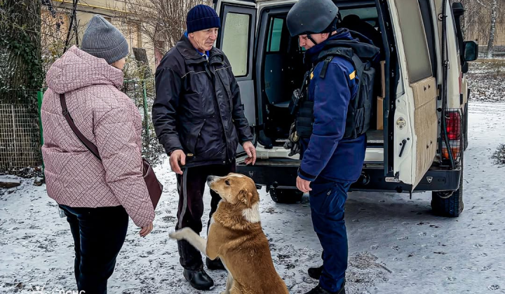 Rescuers evacuate an elderly couple