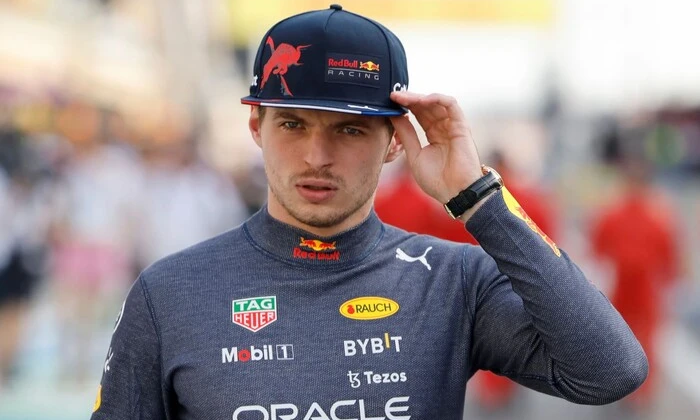 Verstappen posing with his car