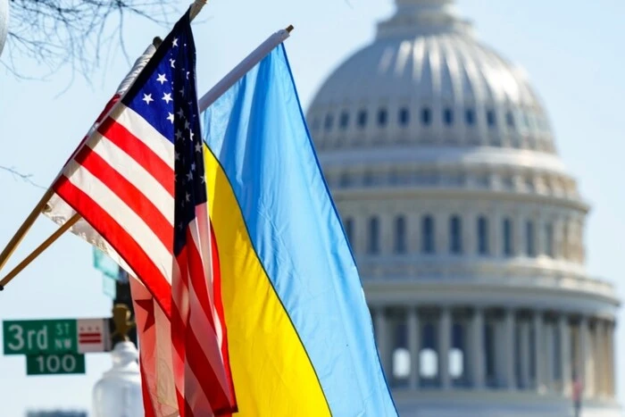 Вертоліт з прапором США на фоні білого хмарного неба